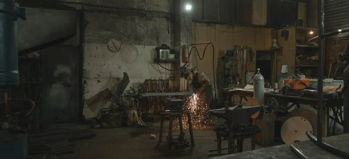 Industrial welder working on a metal component; Pexels photo by Tima Miroshnichenko.